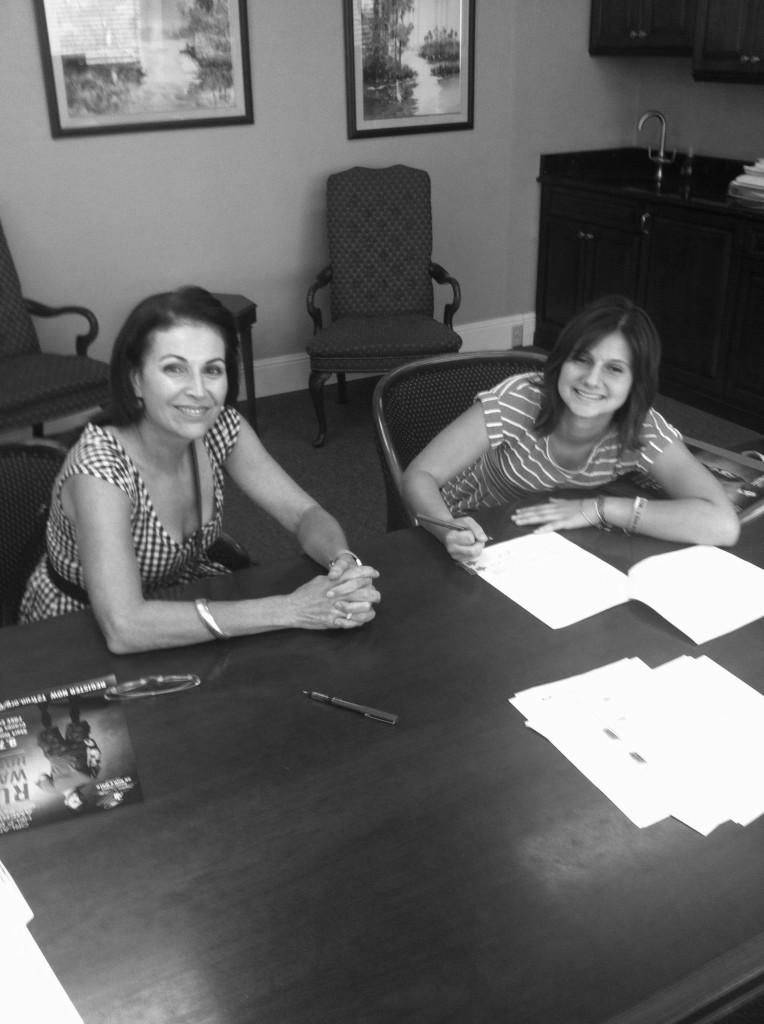 Junior Jessica Kotnour (right) signs her tax exempt form with her mentor Debbie Stockton (left).