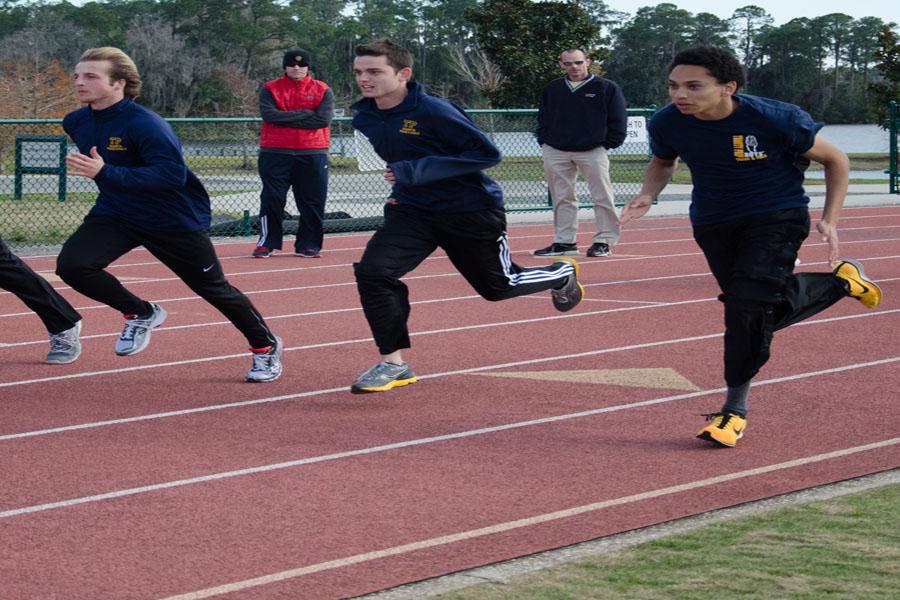 (Left to Right) Junior Michael Wartski warms up with senior runners Robert Simms and Andrew Hewitt.