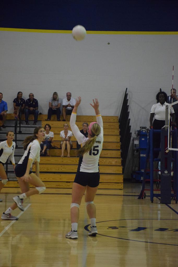 Katie Lowe sets the ball to a teammate for a kill. 