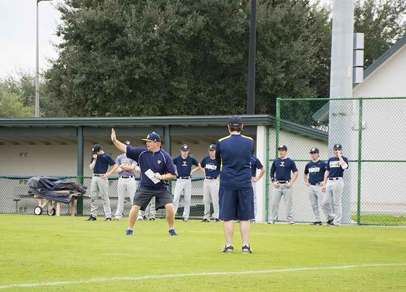 Berryhill (left) begins the first official week of baseball practice by demonstrating techniques for his players to imitate.