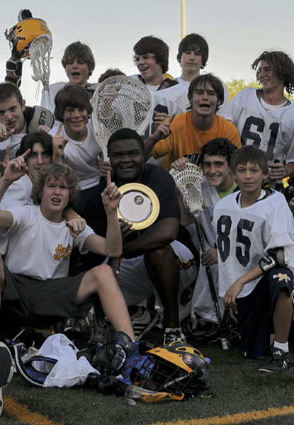 Lawson (center) with the St. Mark’s School boys lacrosse team after winning the city 
championship.