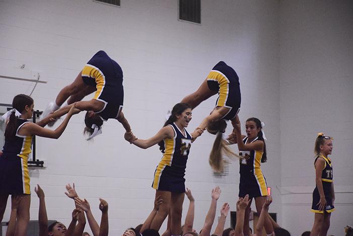 The cheerleaders incorporate intricate stunts into their performance.