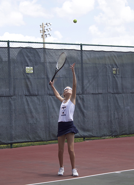 Catherine practices serving before her match against Circle Christan School.