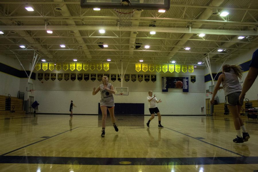 Members of the girls’ team run a drill during open gym as they prepare for the season.