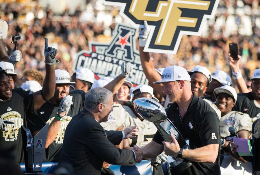 Scott Frost celebrates with his time after their thrilling 62-55 win in the Conference America championship game.  