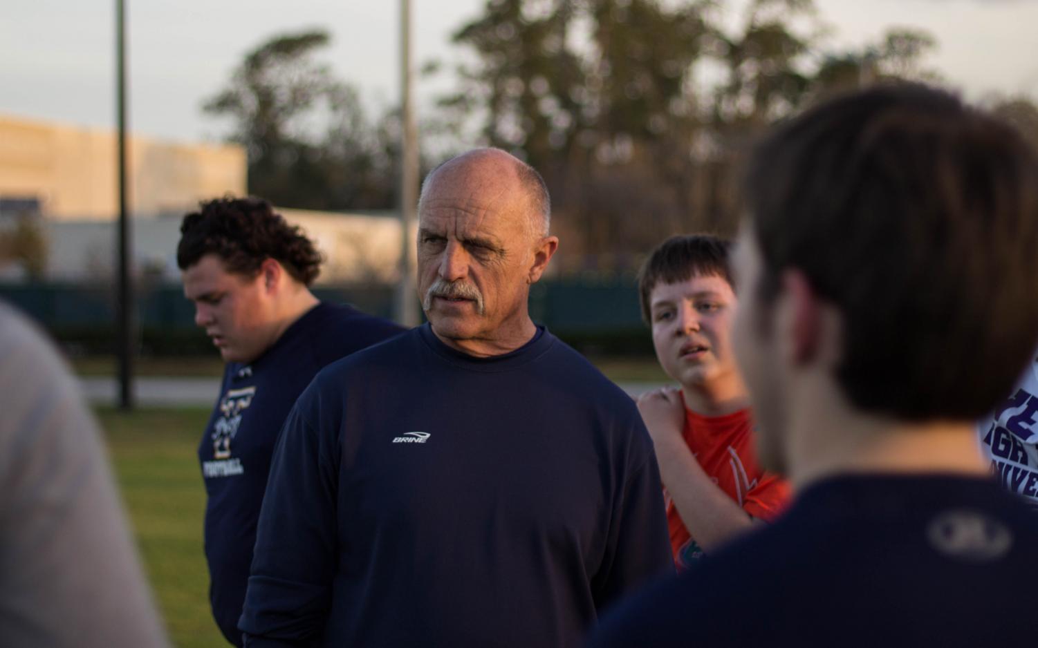 Coach Marty Schriefer speaks to members of the lacrosse team during a hard practice before the season begins.
