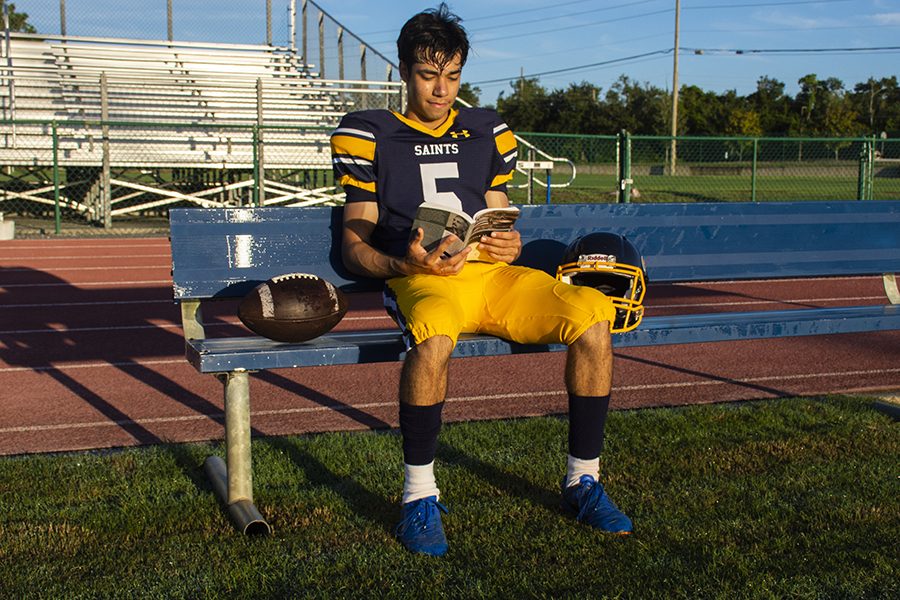 Junior Collin Swan studies up for his English test, while waiting on the sidelines.  