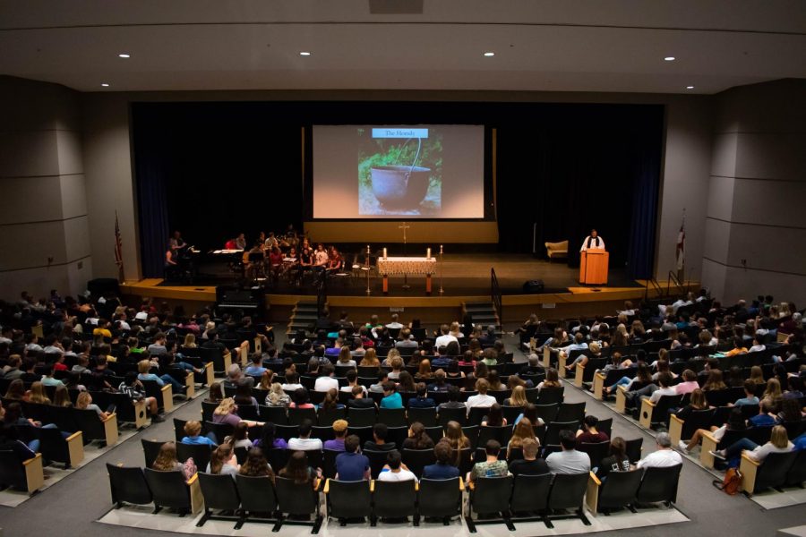 Students in Upper School laugh at a joke made by Father Towers in chapel. The new seating arrangements by advisory were implemented this year.