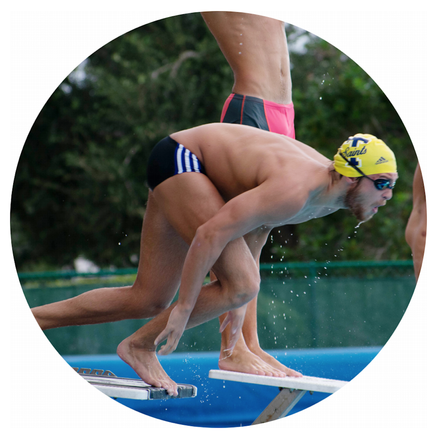 Luke Uttley 20 positions himself on the diving block in preparation of his diving exercise. Uttley hones his diving skills so that he can travel further under the water before having to surface and begin his strokes.