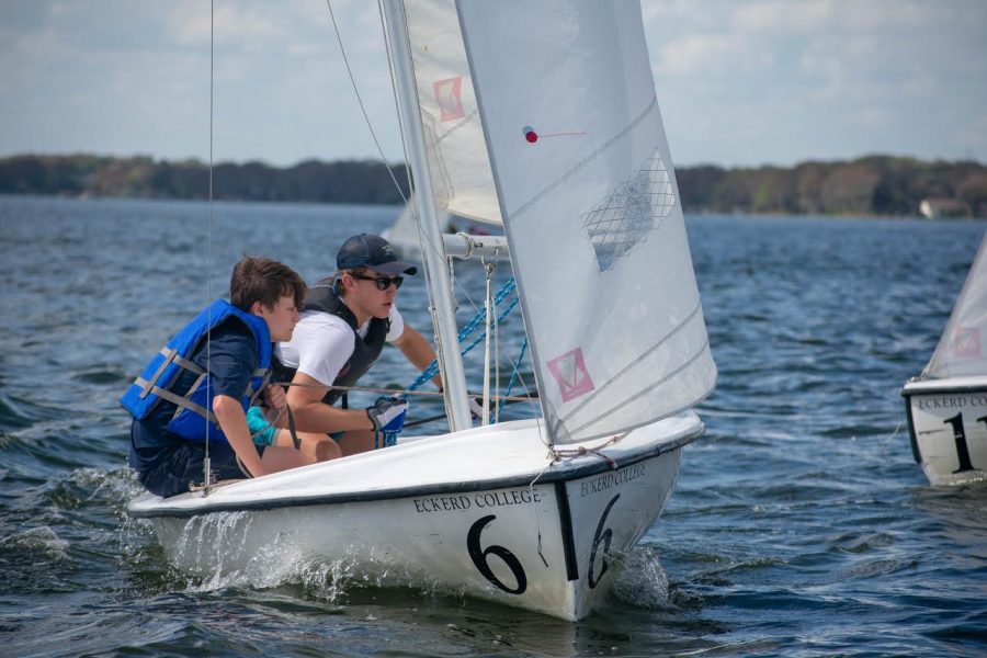 Freshman Nolan Evans and junior Andrew Dryden talk through their plan while waiting for the next practice race to start. Drydens experience in sailing helps inexperienced sailors like Evans to get an easier grasp on how to efficiently sail and win regattas. 