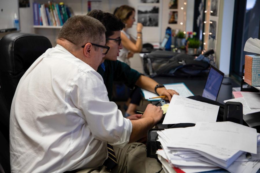 Donald Worcester works with senior Daniel Galvez in the new workspace for department chairs, nicknamed the fishbowl.