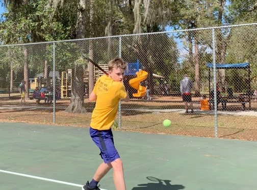 Lachlan Bill continues to practice tennis at Phelps Park