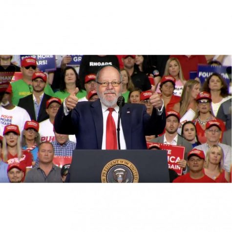 Rhoads speaks to a crowd of cheering supporters at his latest rally.