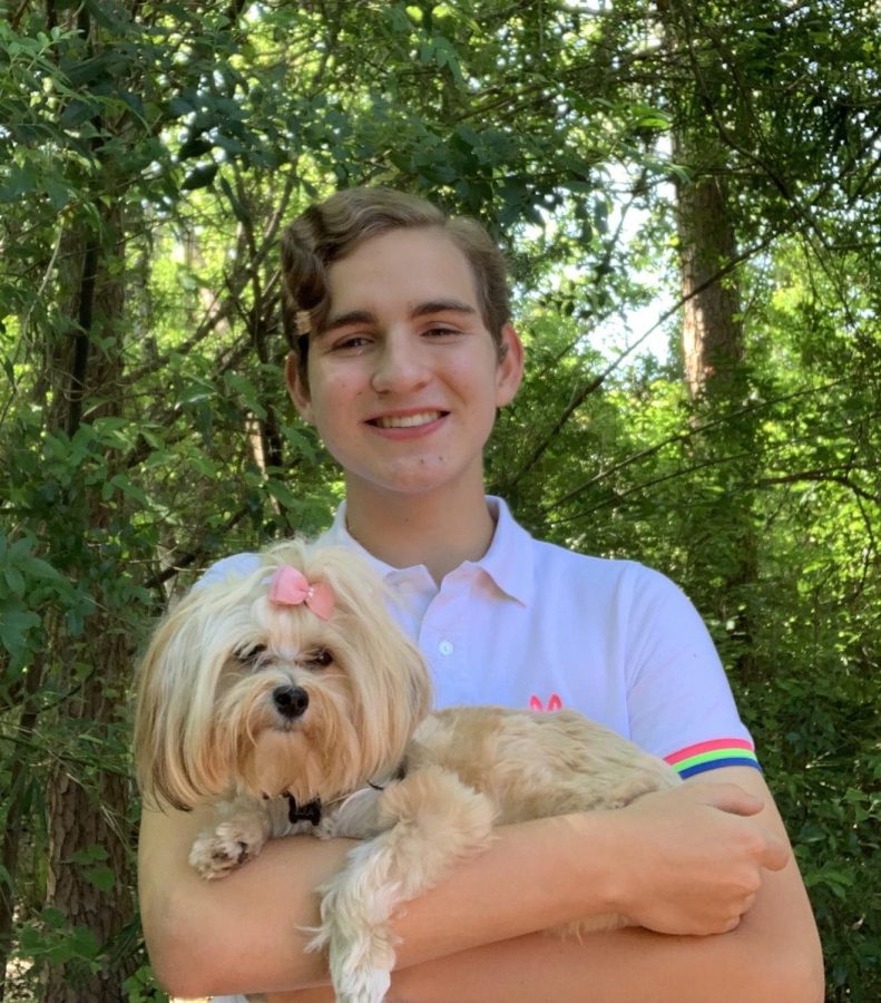 Seventh grader Austin Koepke holds his dog, Lola, who he adopted during the pandemic.