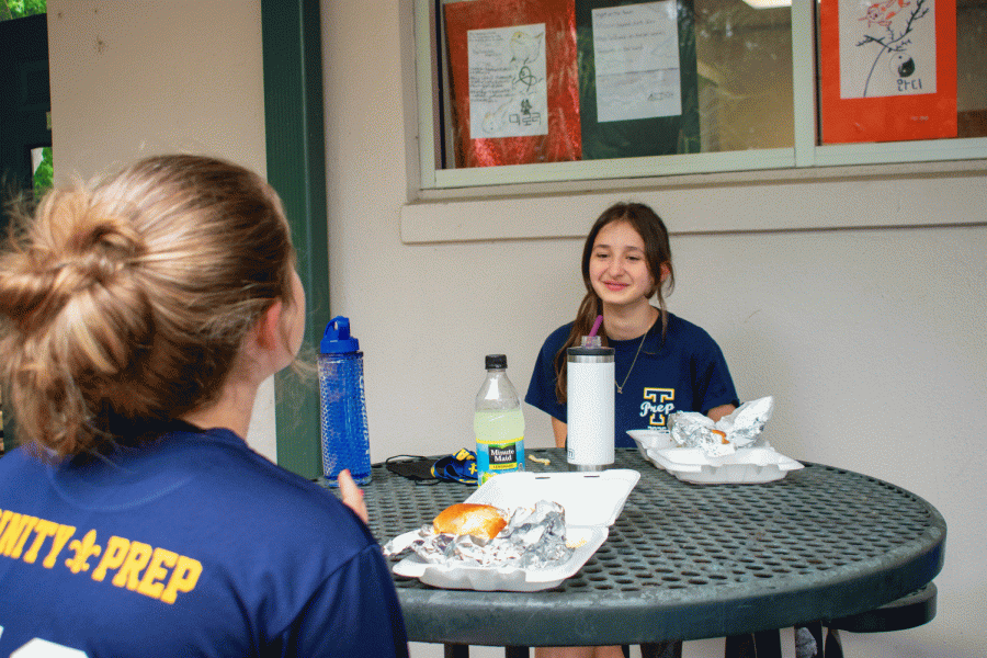 8th grader Jacqueline Stenzel, who came to Trinity at the start of the second semester, enjoys a socially distant lunch with her friends.