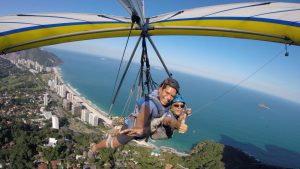 Figueroa-Ortiz (pictured left) goes hang gliding with a guide in Rio de Janiero, Brazil.