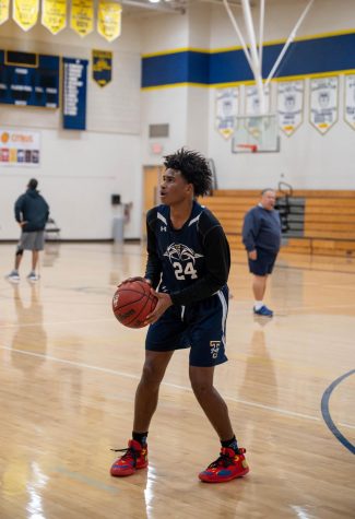 Freshman Demerius Williams practices plays and works on drills during varsity practice to improve his skills for the JV basketball season.
