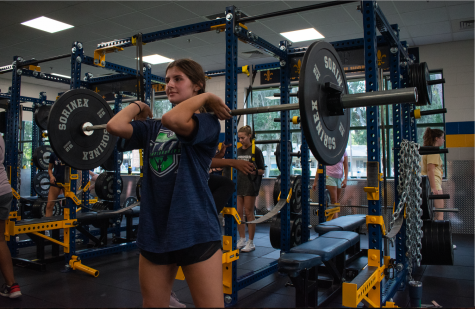 Senior weightlifter Alexia Steinberg lifts after school. However, if the weight room were open throughout the day, she would be able to come during the school day or off season. 