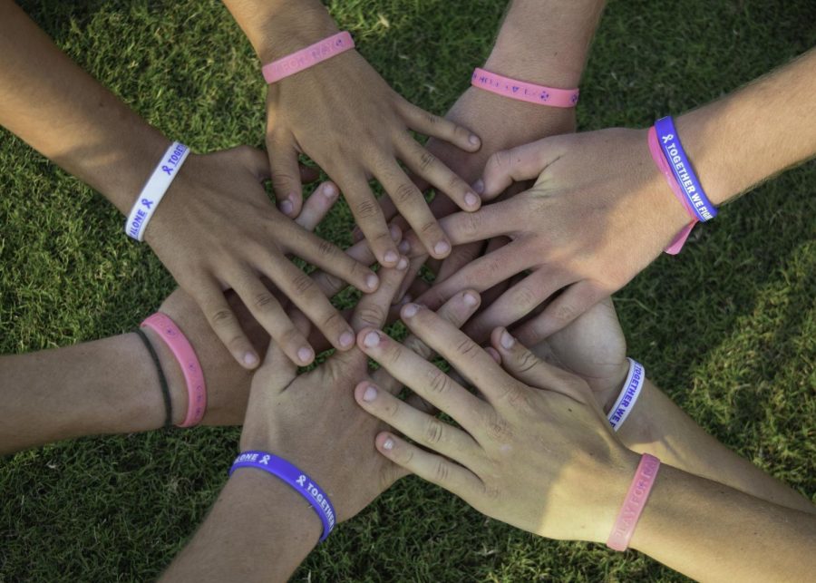 Members of the soccer team gather in support for Ray by wearing cancer awareness bracelets. The players gave these out to their peers and fellow teammates. 
