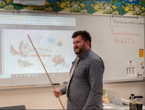 Mr. Thollander, sixth grade science teacher, is up at the front of his classroom teaching about climate change. His students love participating in classroom discussions on topics like this. 