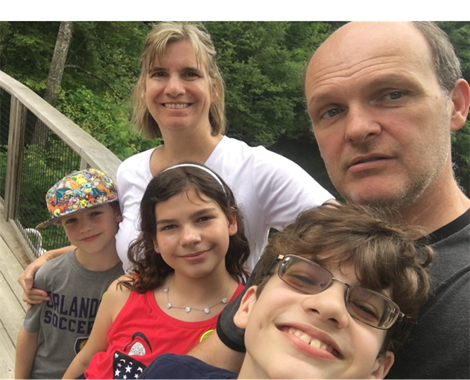 Henderson+and+his+three+children+enjoying+a+hike+in+Vermont.+