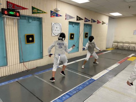 8th grade fencer Ryo Kimura (left) takes on freshman fencer Hannah
Wang (right) in a fencing bout.
