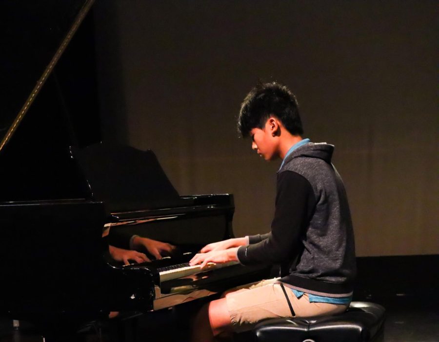 Sophomore Dylan Wang plays piano in the school auditorium. He has been playing piano for seven years, and is now first in the state in piano for three consecutive years. 