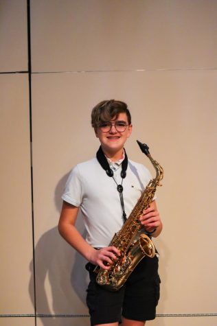 Seventh grade pep band member Sam Sickler prepares to play his saxaphone at practice. 