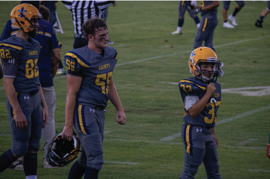 Senior Anthony Miceli and seventh grader Lucas Cordova rest on the sideline during the game against
Taylor High School on September 2. Cordova is one of the six middle schoolers on the team.