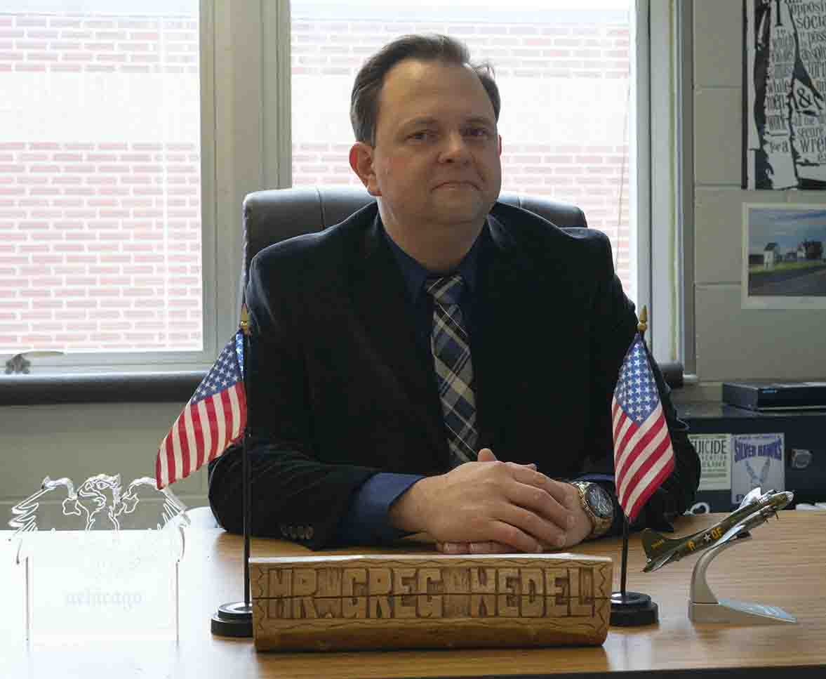 Wedel sits at his desk receiving the Teacher of the Year award at Lake Howell in 2022. 