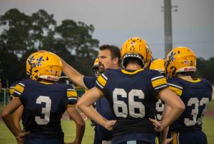 Football head coach Brian Kells directs his players on the Aug. 25 game versus Taylor High.
