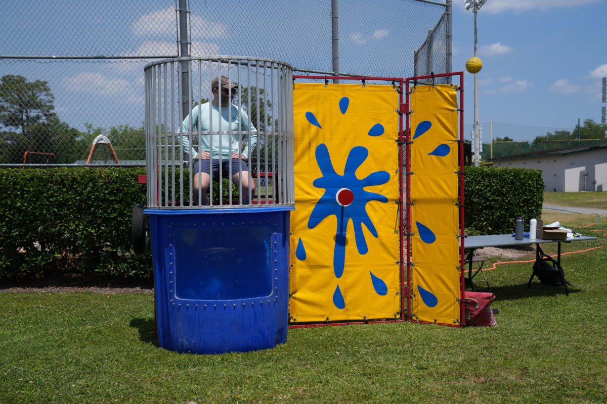 Upper School Dean Kyle McGimsey waits to get dunked in support of autism awareness on April 19. The 9th grade dunk tank was one of many events contributing toward autism awareness.
