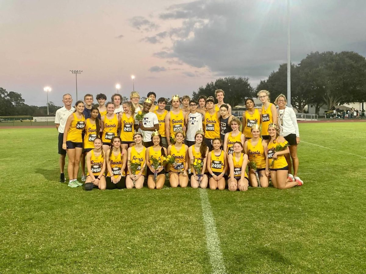 Sara Dowdy poses with her cross country team after a successful senior night on October 24th, 2023.