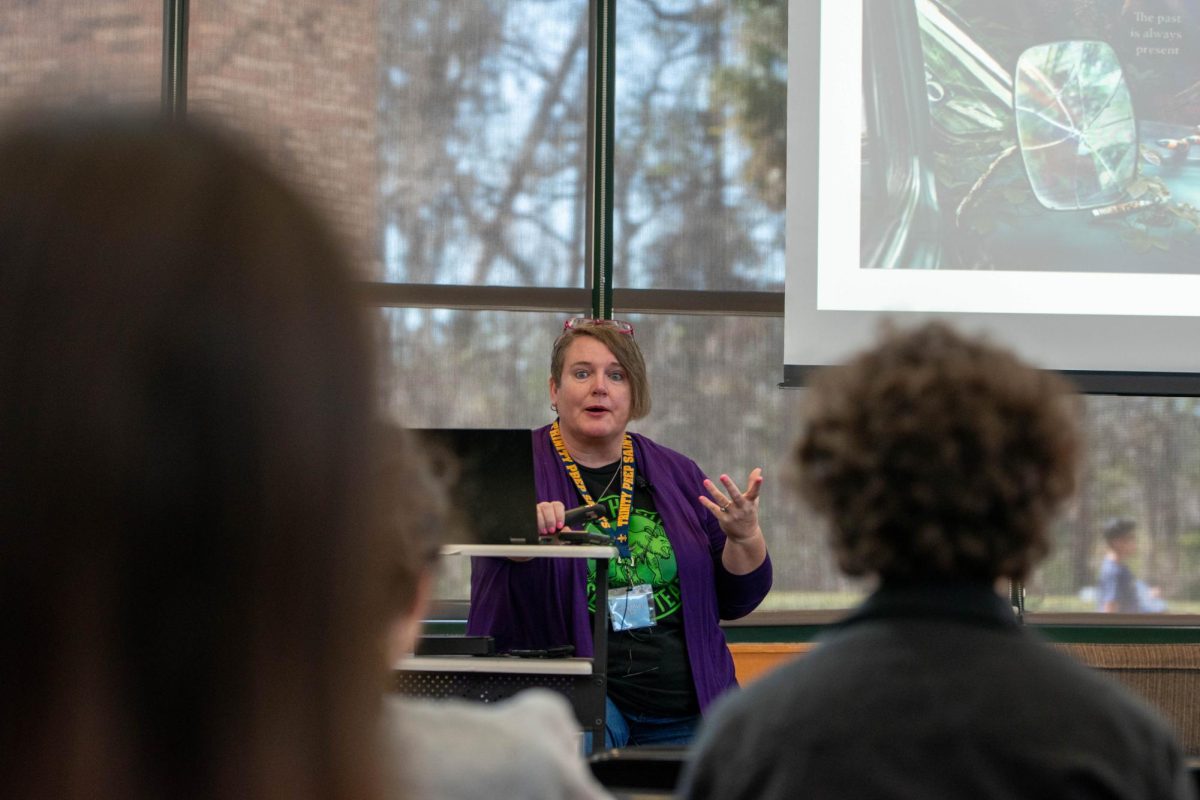 Author Ginny Myers Sain showcases her new fantasy book “When the Bones Sing” to students during middle block. 