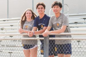 Juniors Charlotte Lightman, Owen Raffa and Victor Fang pose together to advertise the new school store.
Photo by Jordan Johnson, used with permission.