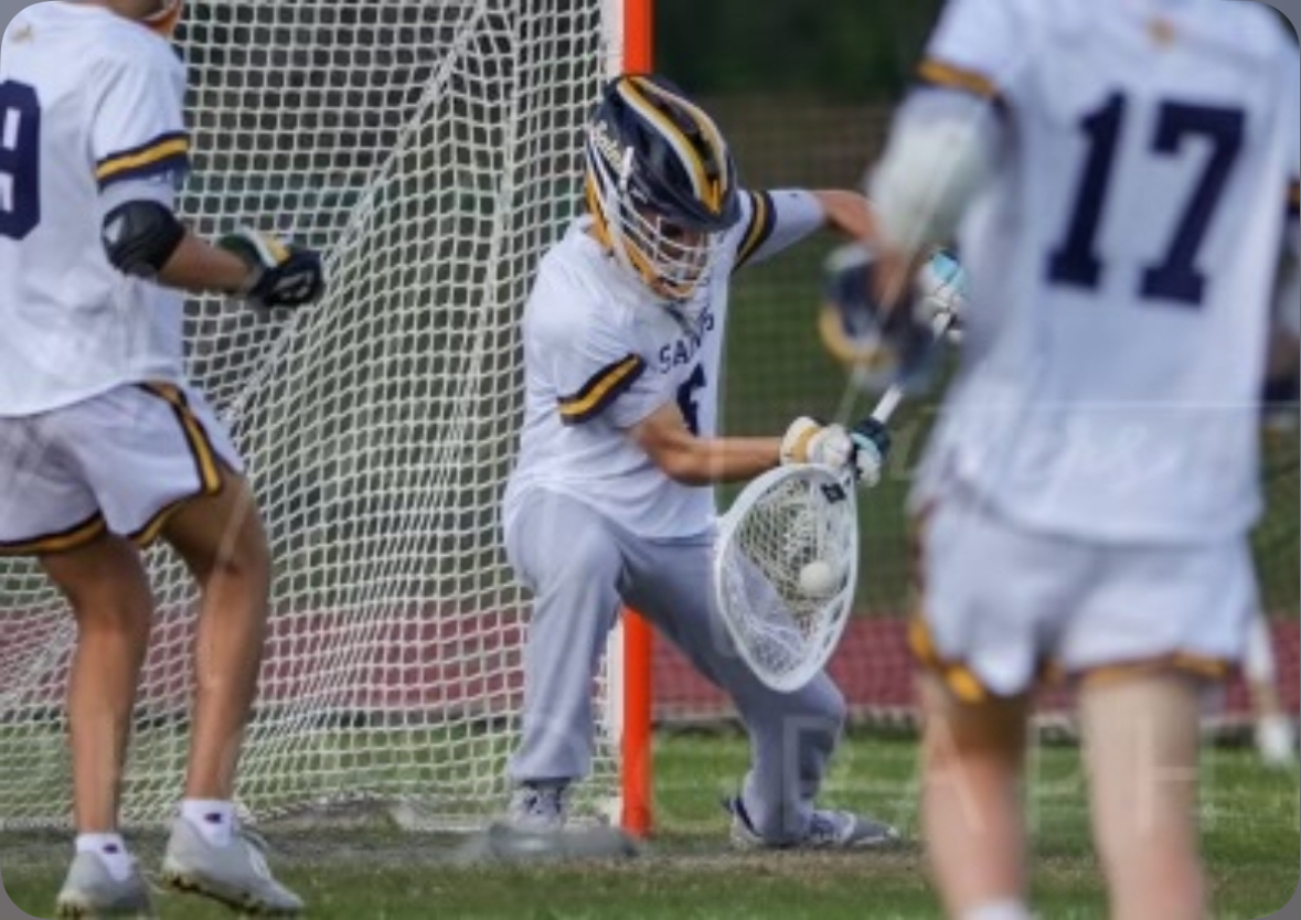 Dedicated athlete Olliver Polsinelli saves a goal during a varsity lacrosse game.