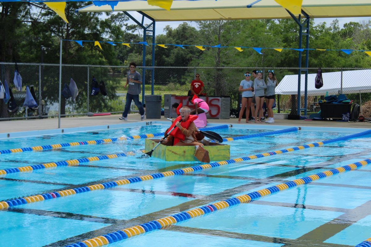 Eighth grader Emmett Brown filled with excitement amidst relying his boat to the other end of the swimming pool.