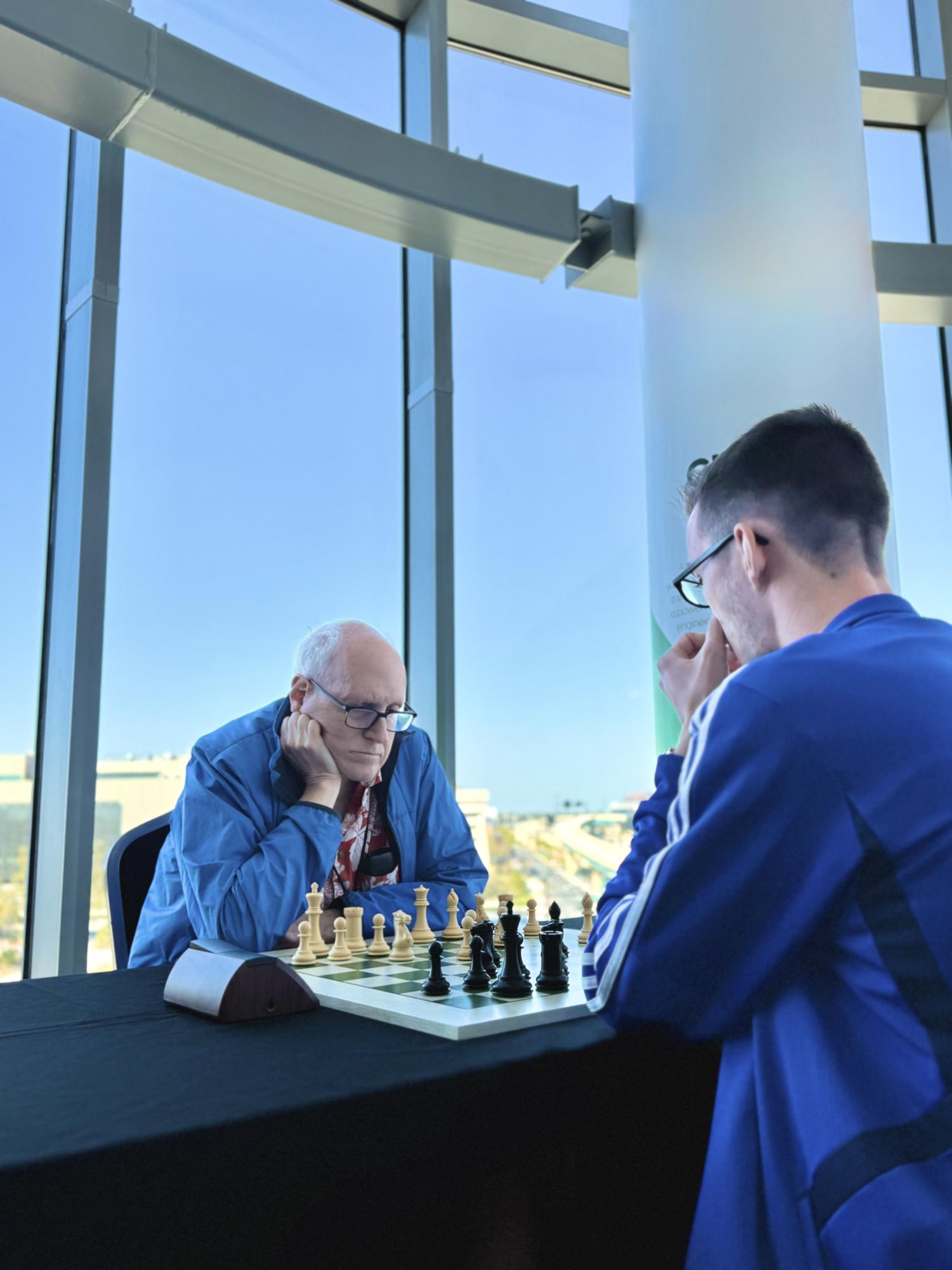 Larry Kaufman (left) plays Life Master Theo Slade (right) at the March 2025 Orlando Magic Championship.
Photo by Larry Kaufman, used with permission.