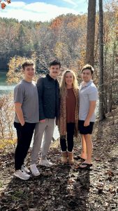 Sockwell and her three sons (Jordan Acker, class of 2023, Josh Acker, class of 2020, Noah Acker, class of 2018) standing in front of their new home in South Carolina.