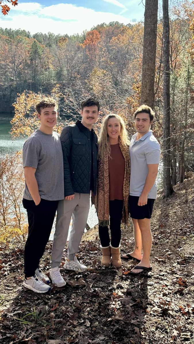 Sockwell and her three sons (Jordan Acker, class of 2023, Josh Acker, class of 2020, Noah Acker, class of 2018) standing in front of their new home in South Carolina.