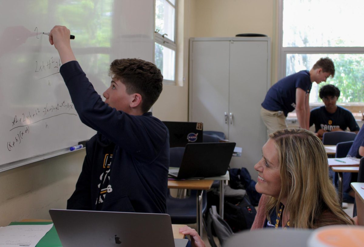 Mikesell teaches limits to junior Oliver Nelson in AP Calculus AB.