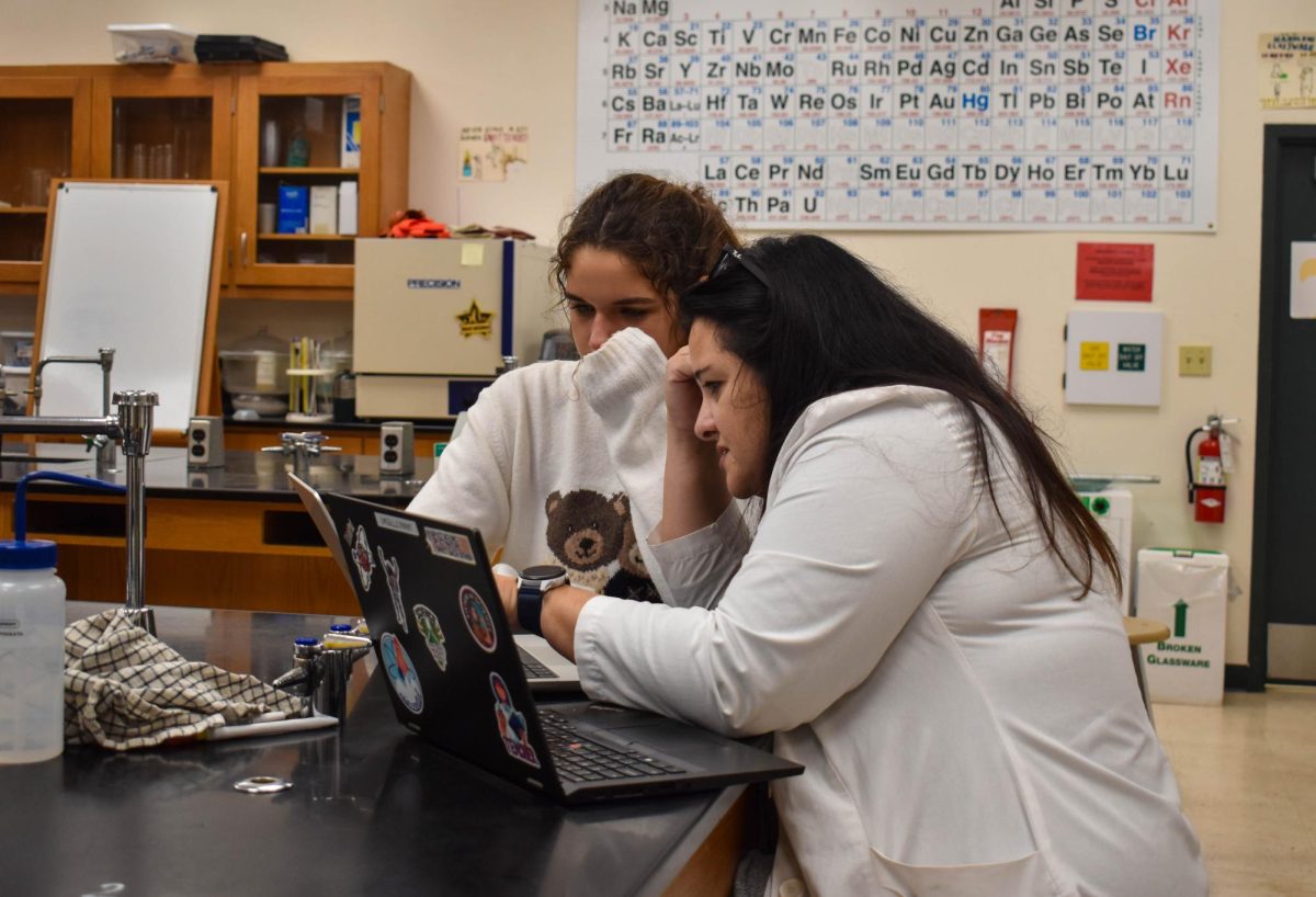 Jannotti helps junior Ava Lieb with an AP Chemistry lab report.