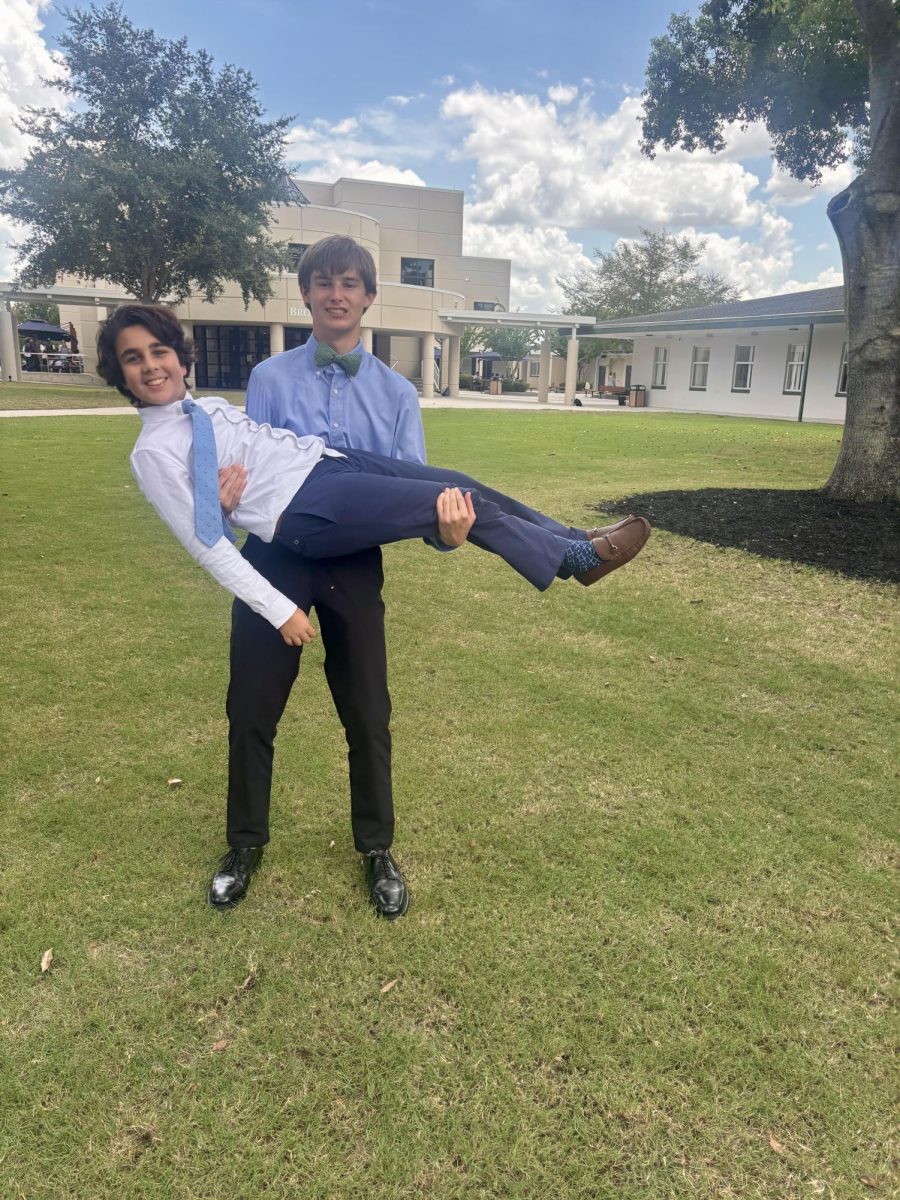 Senior Jack Wermuth and sixth grader Laith Choudry pose after getting paired together at Senior Investiture.