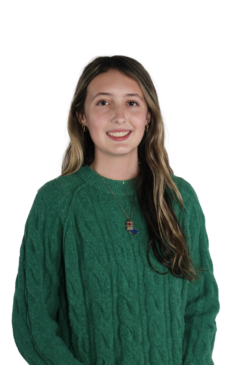Senior Gracie Asher loves wearing a green, cable-knit sweater with some good jewelry.
