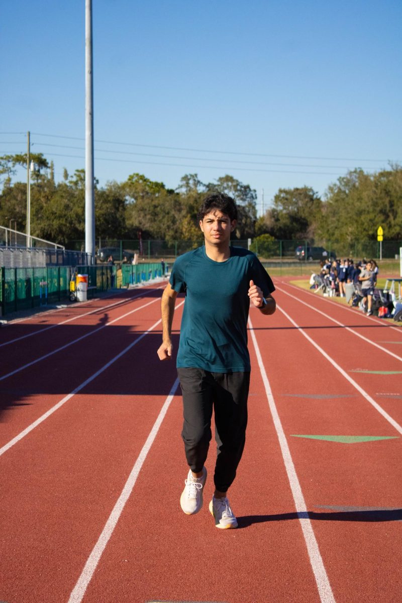 Student athlete Sam Makki runs
on the track during practice, while
still fasting during Ramadan.