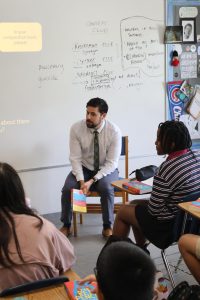 English teacher Dhugal Garnder teaches The Red Pencil to his 6th grade class. After working at Trinity for two years, he will begin teaching English in India next year.